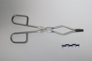 Shows beaker tongs.