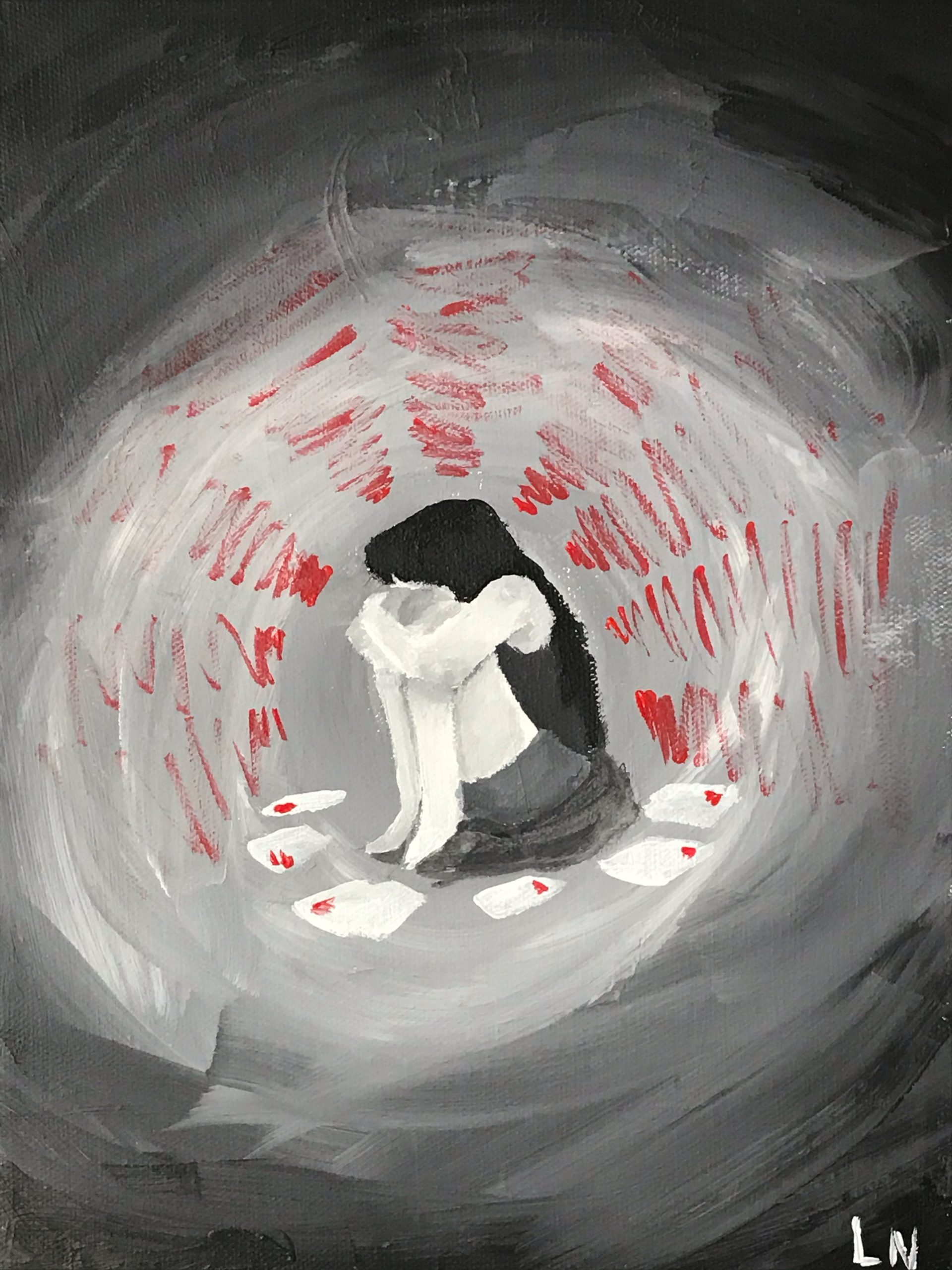 Girl sitting with arms wrapped around knees in distress.